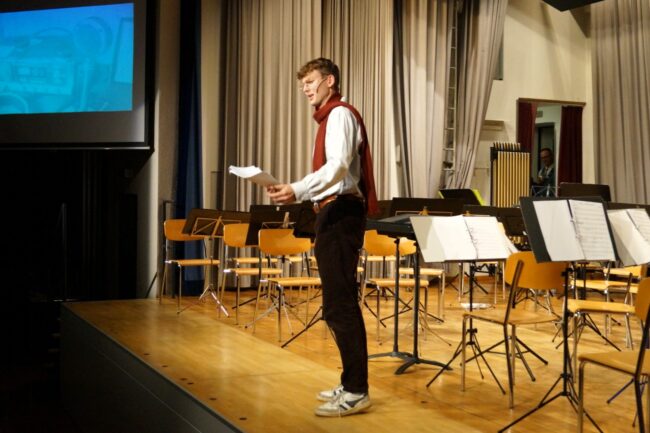 Robin Fischer kündigt die Jugendmusik und Smiling Band Rottal als Eröffnungsformationen an.